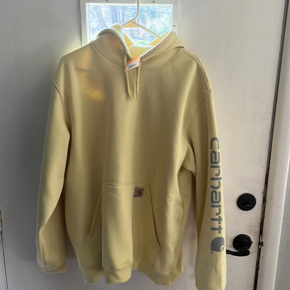 Carhartt loose fit hoodie. The color is lemon grass.